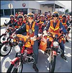 Australia Post workers on motor bikes