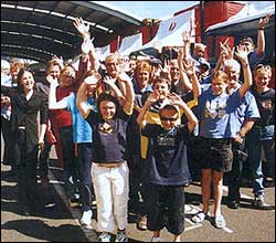 People waving at convoy for kids