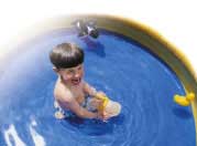 Boy in plastic swimming pool